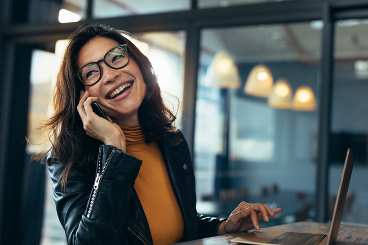 Business woman making a phone call and laughing